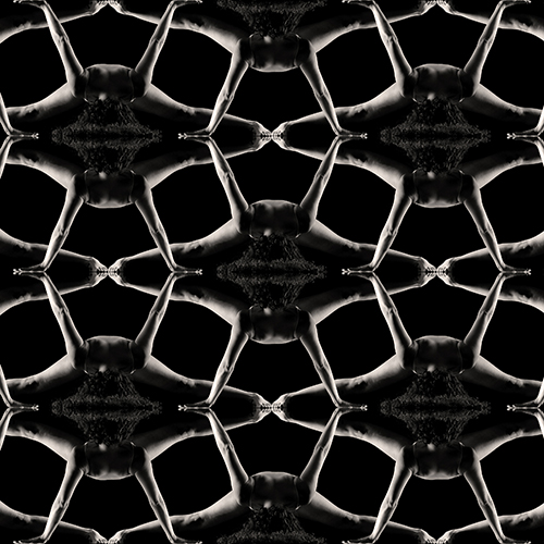 A geometric pattern of interconnected figures with outstretched arms and legs, creating a symmetrical, kaleidoscopic effect against a black background. The figures are arranged in a repetitive, lattice-like design.